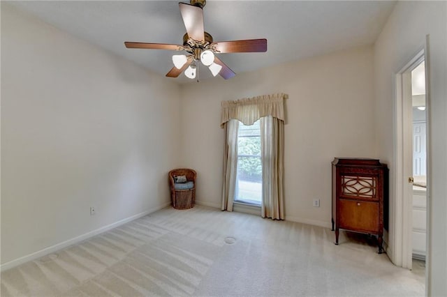 spare room featuring baseboards, a ceiling fan, and carpet