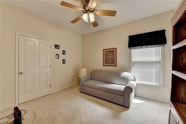 sitting room with carpet floors, ceiling fan, and baseboards