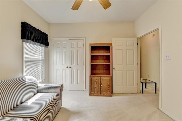 sitting room with carpet floors and a ceiling fan