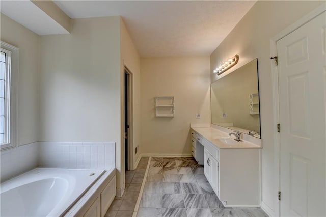 full bathroom with vanity, tile patterned floors, baseboards, and a garden tub