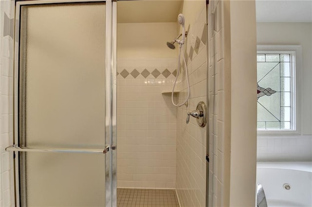 bathroom with a whirlpool tub and a stall shower