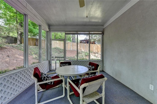 sunroom / solarium with ceiling fan, a healthy amount of sunlight, and outdoor dining space