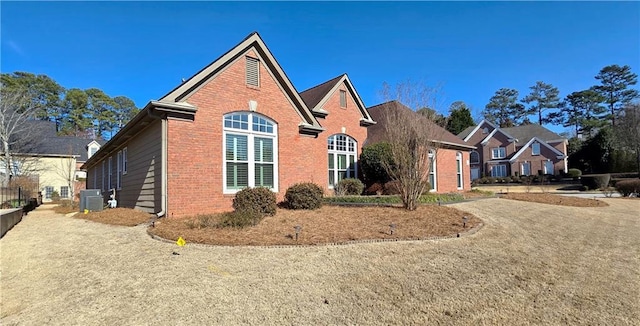 traditional-style home with brick siding and central AC