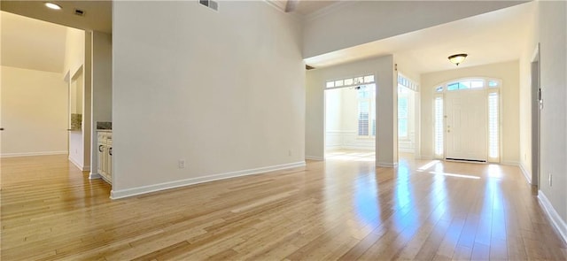 entryway featuring light wood-type flooring, visible vents, and baseboards