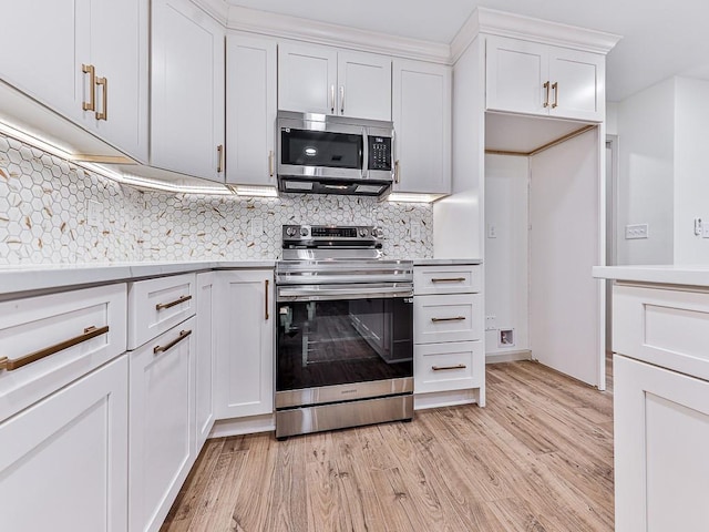 kitchen with light wood-type flooring, light countertops, decorative backsplash, stainless steel appliances, and white cabinetry