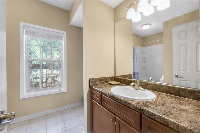 bathroom featuring tile patterned flooring, vanity, and walk in shower