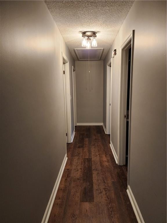 1751 Bridle Ln, Macon, GA 31220 - hallway featuring attic access, a textured ceiling, and dark wood finished floors