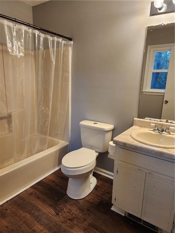 1751 Bridle Ln, Macon, GA 31220 - bathroom with vanity, wood finished floors, and shower / bath combination with curtain