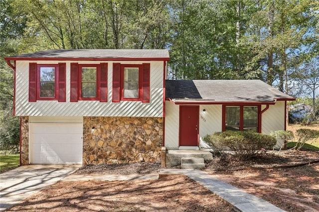 tri-level home featuring covered porch and a garage