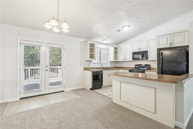 kitchen with light carpet, sink, black appliances, vaulted ceiling, and white cabinetry