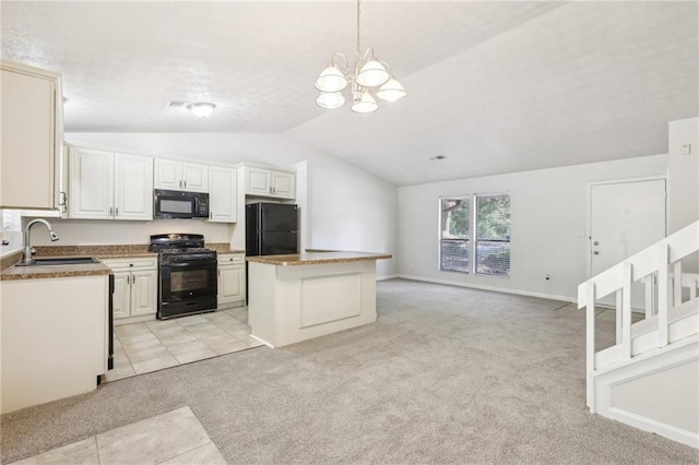 kitchen with sink, black appliances, lofted ceiling, and a kitchen island