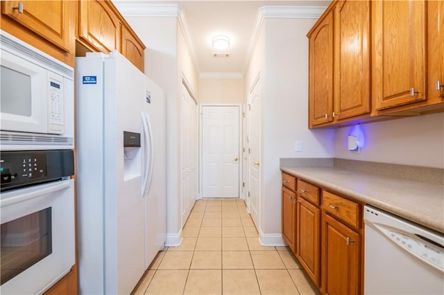 kitchen featuring brown cabinets, light tile patterned floors, ornamental molding, and white appliances