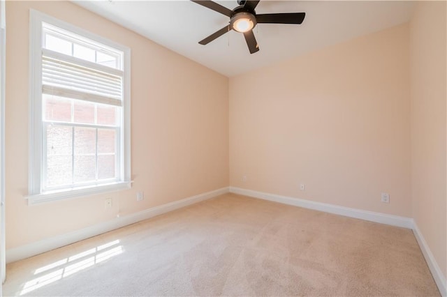 spare room featuring baseboards, a ceiling fan, and carpet flooring