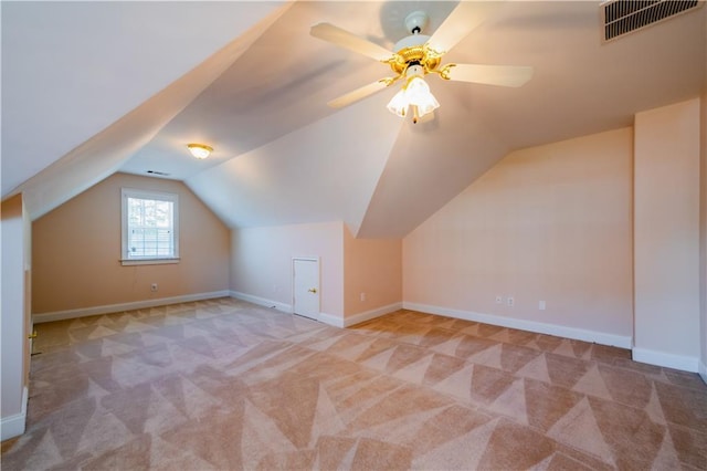 additional living space with lofted ceiling, visible vents, carpet floors, baseboards, and ceiling fan