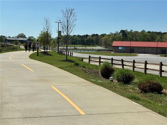 view of home's community featuring fence