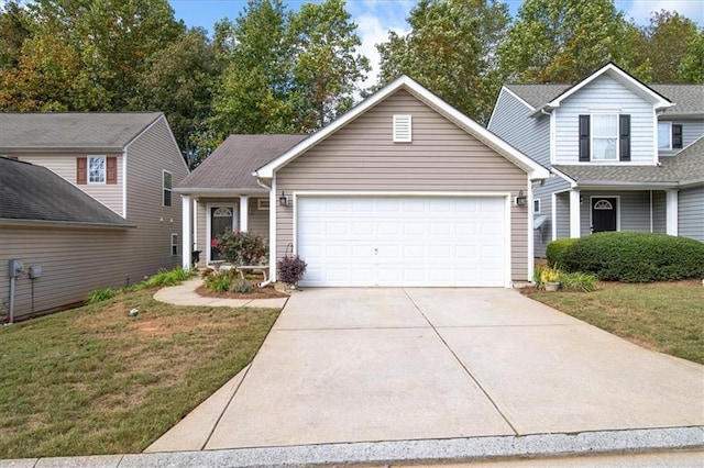 view of front of house featuring a garage and a front lawn