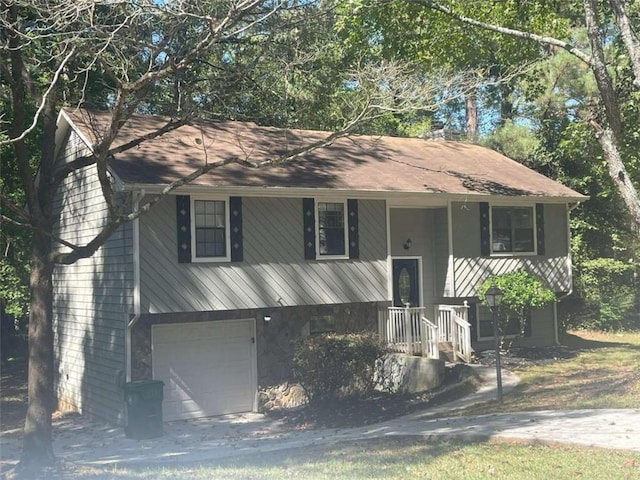 raised ranch with covered porch and a garage