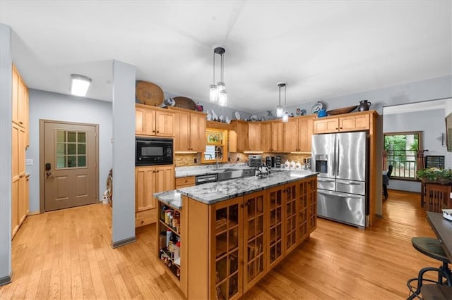 1731 Apple Pie Ridge Rd, Alto, GA 30510 - kitchen with stainless steel appliances, light wood-style flooring, dark stone countertops, and a center island