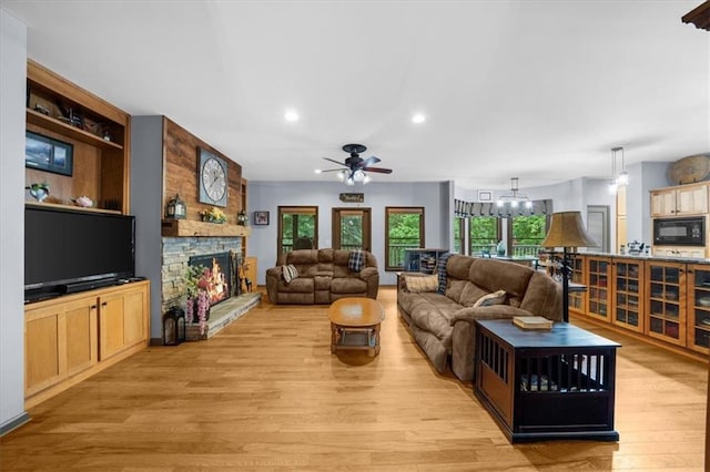 1731 Apple Pie Ridge Rd, Alto, GA 30510 - living area featuring a fireplace, light wood-style floors, a ceiling fan, a chandelier, and recessed lighting