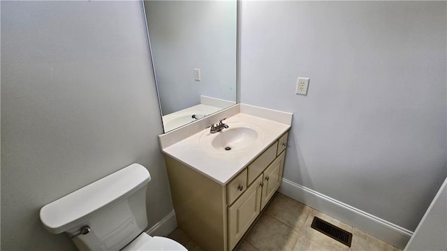 half bath with tile patterned flooring, visible vents, baseboards, toilet, and vanity