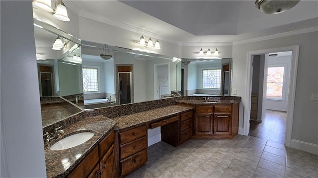 full bathroom featuring baseboards, a tub, a stall shower, ornamental molding, and a sink