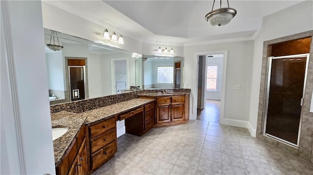 full bathroom featuring a stall shower, vanity, baseboards, and ornamental molding