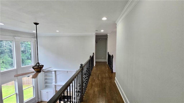 hallway with crown molding, baseboards, an upstairs landing, recessed lighting, and wood finished floors