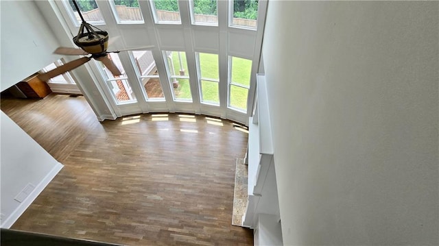 unfurnished living room featuring wood finished floors and a ceiling fan