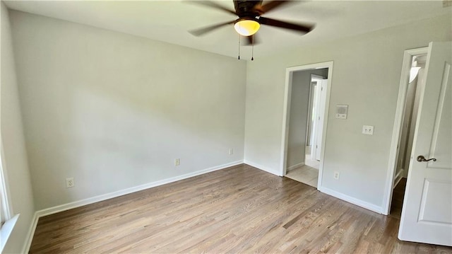 unfurnished bedroom featuring baseboards, wood finished floors, and a ceiling fan