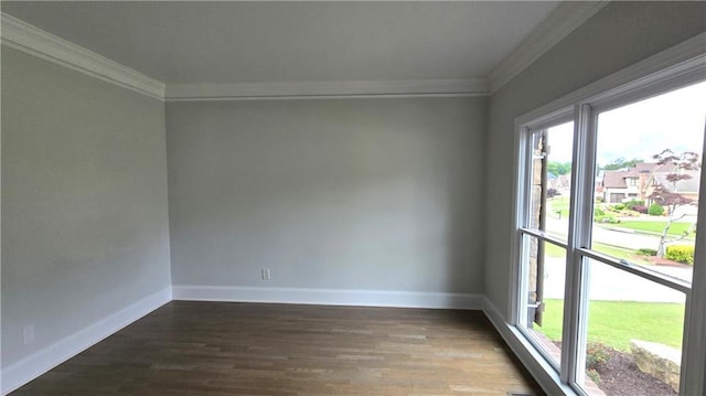 unfurnished room featuring dark wood-style floors, baseboards, and ornamental molding