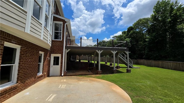 view of yard with stairs, a deck, a patio area, and fence