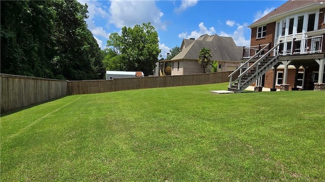 view of yard featuring stairway and a fenced backyard