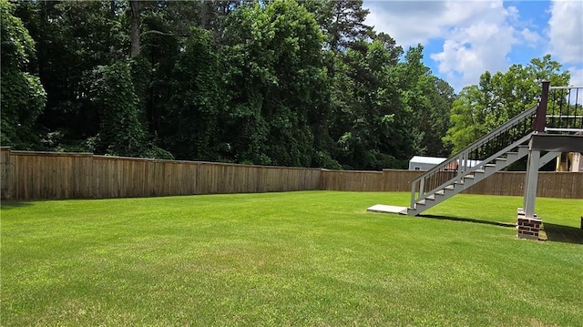 view of yard featuring stairway and a fenced backyard