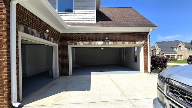 garage featuring concrete driveway