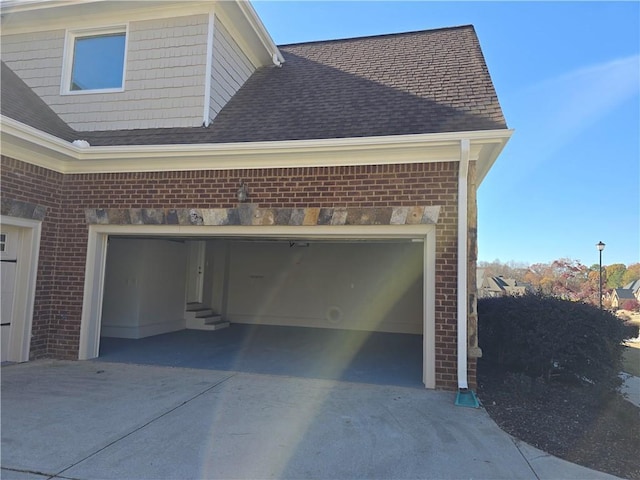 garage featuring concrete driveway