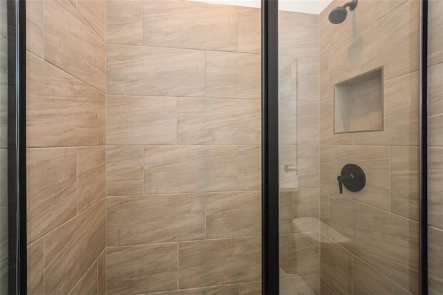 bathroom with tiled shower