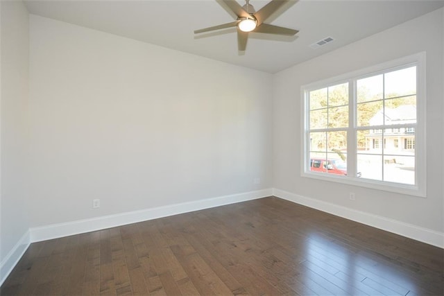 empty room with ceiling fan and dark wood-type flooring