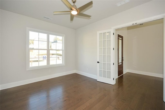 unfurnished room featuring ceiling fan, dark wood-type flooring, and french doors