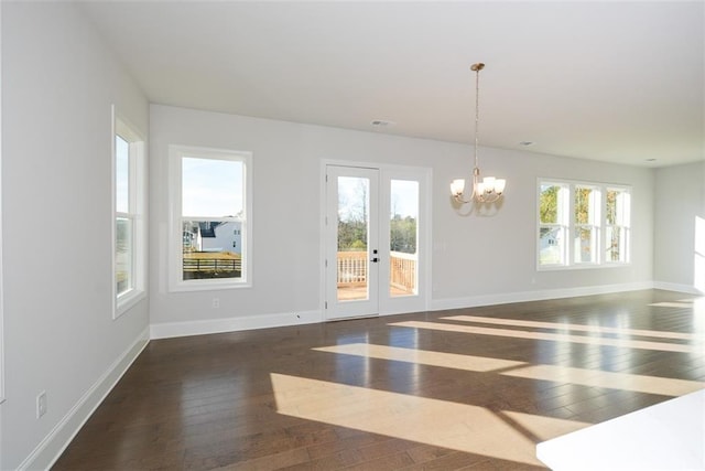 interior space featuring dark wood-type flooring and a notable chandelier