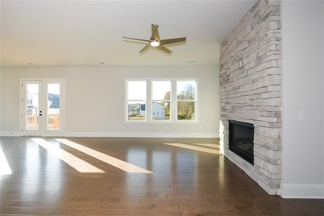 unfurnished living room with a fireplace, dark hardwood / wood-style flooring, and ceiling fan