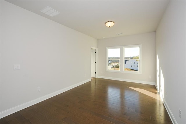 spare room with dark hardwood / wood-style floors