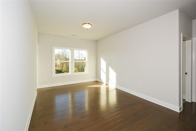 spare room featuring dark hardwood / wood-style floors