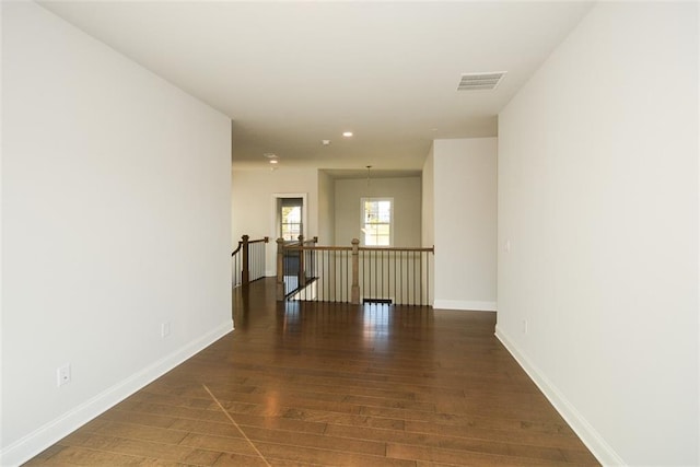 corridor with dark hardwood / wood-style flooring