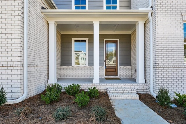 entrance to property featuring a porch