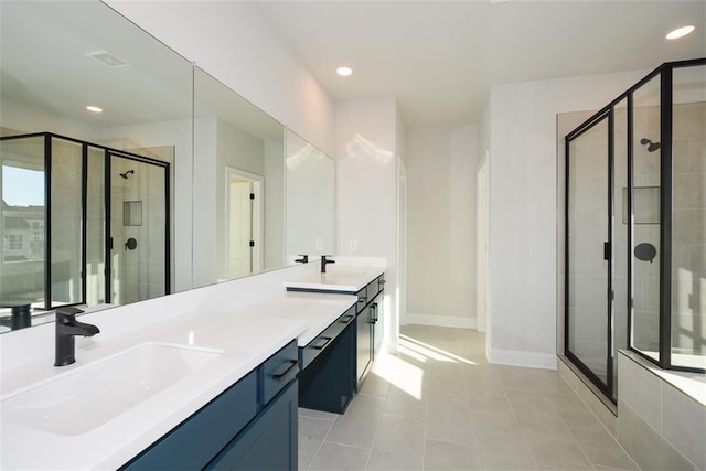 bathroom featuring tile patterned flooring, vanity, and a shower with door