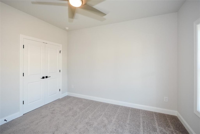 unfurnished room featuring ceiling fan and light colored carpet