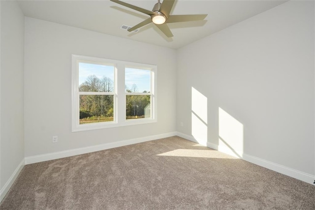 unfurnished room with ceiling fan and light carpet