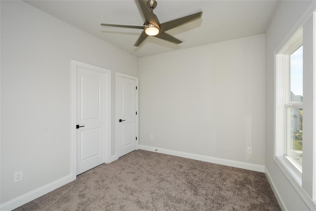 empty room with carpet floors and ceiling fan