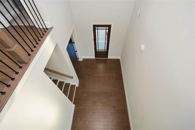 entrance foyer with dark hardwood / wood-style flooring and a high ceiling