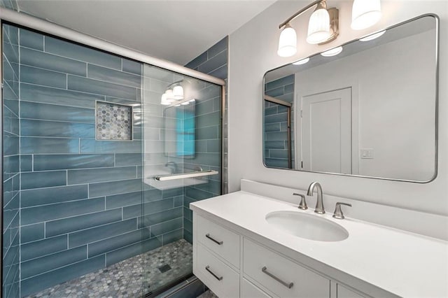 full bathroom with vanity and a shower stall
